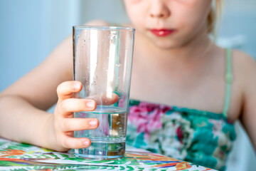 Little girl drinking a fresh glass of water