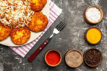top view fried cutlets with cooked rice and seasonings on a dark background rissole dish meat