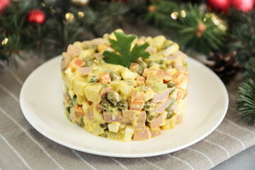 Traditional russian salad Olivier served on light table, closeup