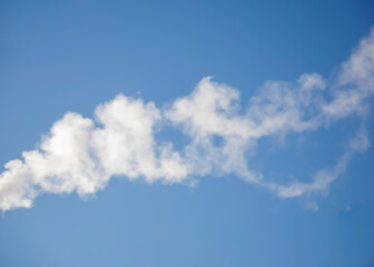 White smoke, steam on the blue sky from  heating plant.
