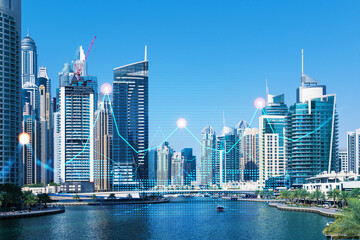 Fototapeta premium Skyscrapers of Dubai business downtown. International hub of trading and financial services of Western Asia. FOREX graph and chart concept. Double exposure. Dubai Canal waterfront.