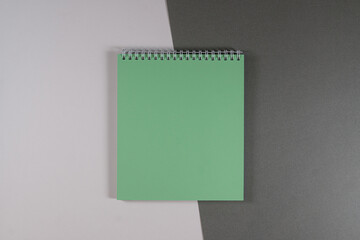 green office notebook on white gray background