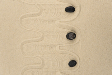 Zen sand garden meditation stone background with copy space. Stones and lines drawing in sand for...