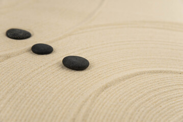Zen sand garden meditation stone background with copy space. Stones and lines drawing in sand for...