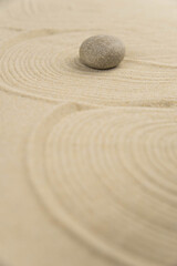 Fototapeta na wymiar Zen sand garden meditation stone background with copy space. Stones and lines drawing in sand for relaxation. Concept of harmony, balance and meditation, spa, massage, relax. Set Sail Champagne color