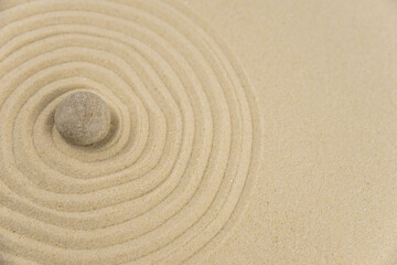 Zen sand garden meditation stone background with copy space. Stones and lines drawing in sand for...