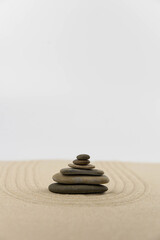 Zen sand garden meditation stone background with copy space. Stones and lines drawing in sand for relaxation. Concept of harmony, balance and meditation, spa, massage, relax. Set Sail Champagne color