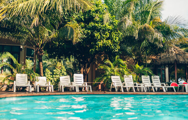 Lounge chairs near the pool at the hotel.