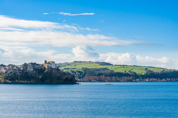 Fototapeta premium Landscape of lake, cliff and hills of the italian city called Anguillara