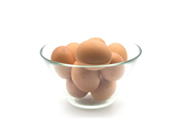Closeup of fresh organic eggs in a transparent bowl on white background