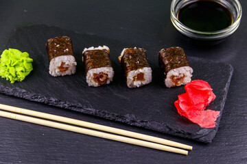 Sushi maki rolls with tuna on black slate