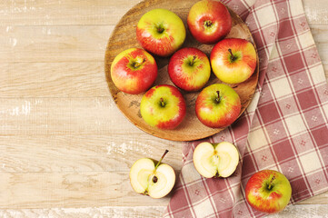 Ripe red apples on wooden plate
