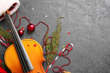Violin and Christmas decor on dark background
