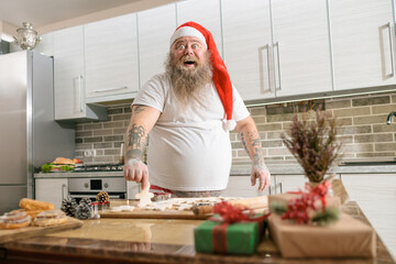 Emotional fat funny and tattooed man with food at the kitchen at home