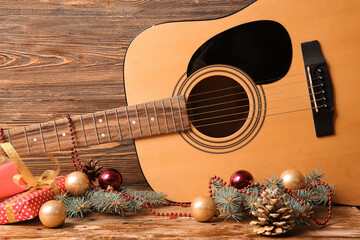 Guitar with Christmas decor on wooden background