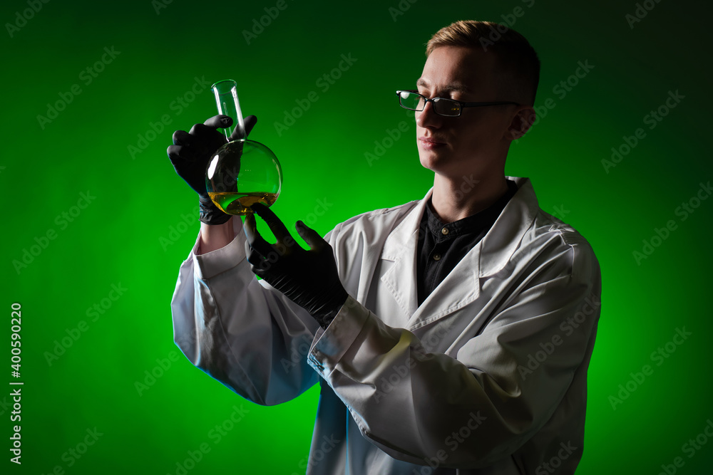 Poster chemist with a flask. a chemist examines a flask of reagent. a lab technician in a white coat examin