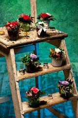 Christmas flower arrangements on a stepladder