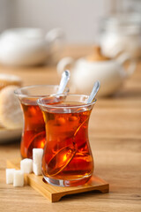 Cups of hot Turkish tea on wooden table