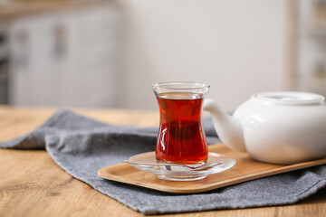 Cup of hot Turkish tea on table