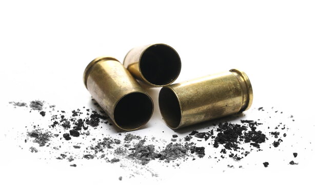 9mm pistol bullet casings with gunpowder pile isolated on white background