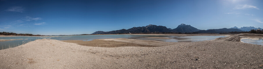 Panorama of lake Forggensee, water reservoir without water, near Fussen in Bavaria, Germany