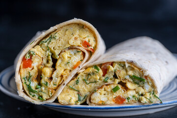 Burrito wraps with egg omelet and vegetables in pita bread