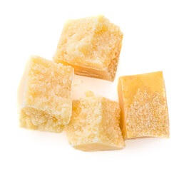 Pieces of Parmesan cheese isolated on white background. Yellow cheese chunks, Top view.