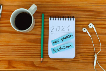 new year's resolutions for 2021 written in notebook on the table