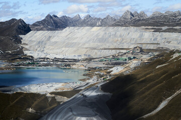 mine in the high country of the andes mountains in Peru, with view over a lake, terraces of...