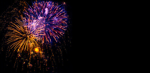 Holiday Fireworks at New Year Eve. Abstract Festive background with fireworks sparkles. Copyspace.