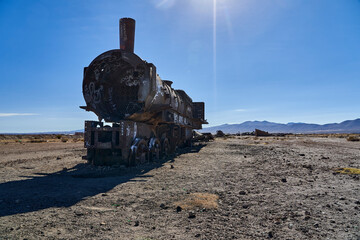 old rusty trains at the antique train cemetery close to the salt flats of Uyuni in Bolivia, rusting away in the sun. Lost places at the salar de Uyuni, Alti plano. 