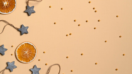 Orange slices, wooden stars and cake sprinkles. Top view. Copy space.