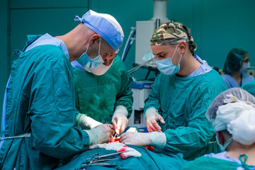 Team of surgeons operating in a hospital