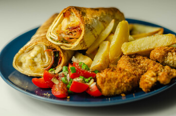 Tortilla wrap with chicken and beechwood smoked bacon served with chicken nuggets and chips