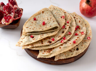 Gozleme or kutabs with herbs and cheese. Or the Dagestani dish chudu - stuffed flat cakes fried in a dry pan.