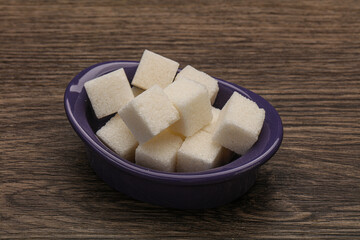 Refined white sugar cubs in the bowl