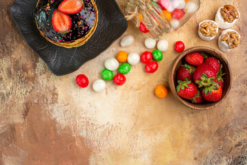 top view sweet pancakes with fruits and colorful candies on wooden desk cake dessert sweet pie