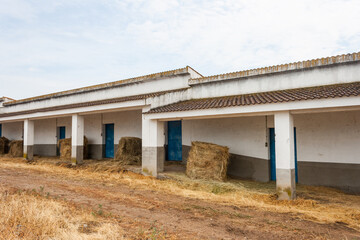 Fototapeta na wymiar A barn without walls with bales of straw inside.