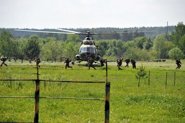 Soldiers of a special forces unit land from a helicopter for a combat mission