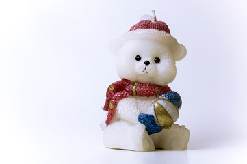 Candle in the form of a Christmas bear on a white background