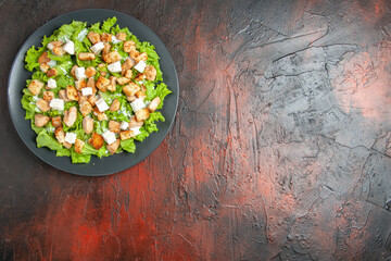 top view caesar salad on oval plate on dark red background free place