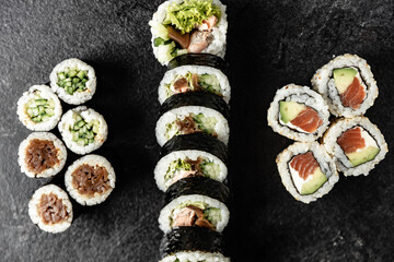 Sushi Rolls. Sushi Rolls Set, maki, philadelphia and california rolls, on a Black background.