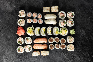 Obraz na płótnie Canvas Sushi Rolls. Sushi Rolls Set, maki, philadelphia and california rolls, on a Black background.