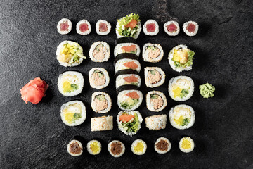 Fototapeta na wymiar Sushi Rolls. Sushi Rolls Set, maki, philadelphia and california rolls, on a Black background.