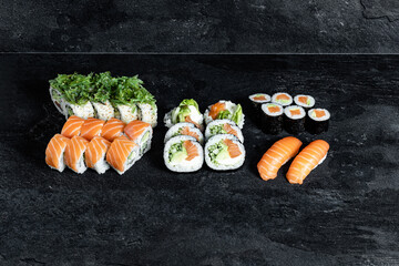 Sushi Rolls. Sushi Rolls Set, maki, philadelphia and california rolls, on a Black background.