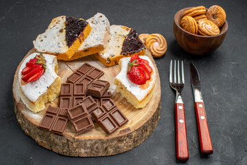 front view cake slices with choco bars and cookies on dark background fruit sweet biscuit