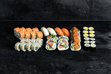 Sushi Rolls. Sushi Rolls Set, maki, philadelphia and california rolls, on a Black background.