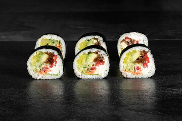 Sushi Rolls. Sushi Rolls Set, maki, philadelphia and california rolls, on a Black background.