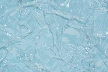 Wrinkled cling film, blue vinyl art background, wet effect texture.