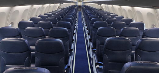 Empty passenger seats in the aircraft cabin.